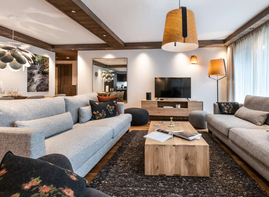 This stunning living room boasts a spacious and open layout, featuring two plush grey sofas perfect for relaxation.