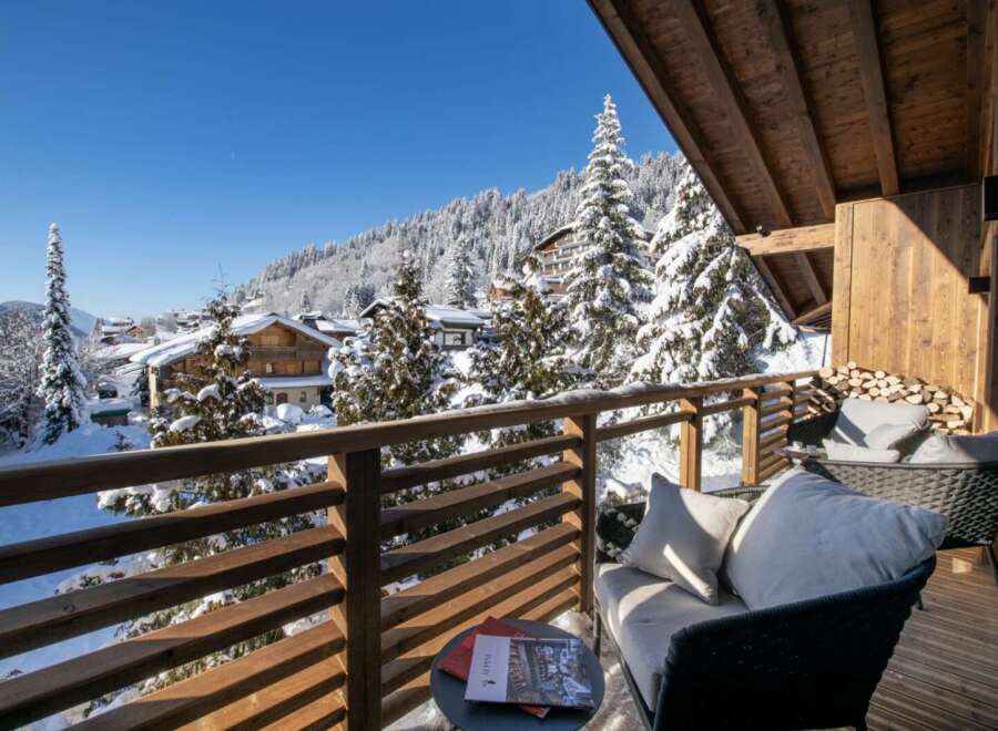 This stunning chalet boasts a private balcony with breathtaking views of the snow-capped mountains and charming village.