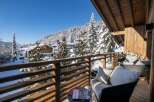 This stunning chalet boasts a private balcony with breathtaking views of the snow-capped mountains and charming village.