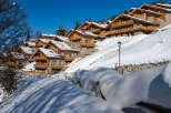 Luxury chalet homes nestled on a snowy hillside, offering stunning mountain views and breathtaking winter landscapes.