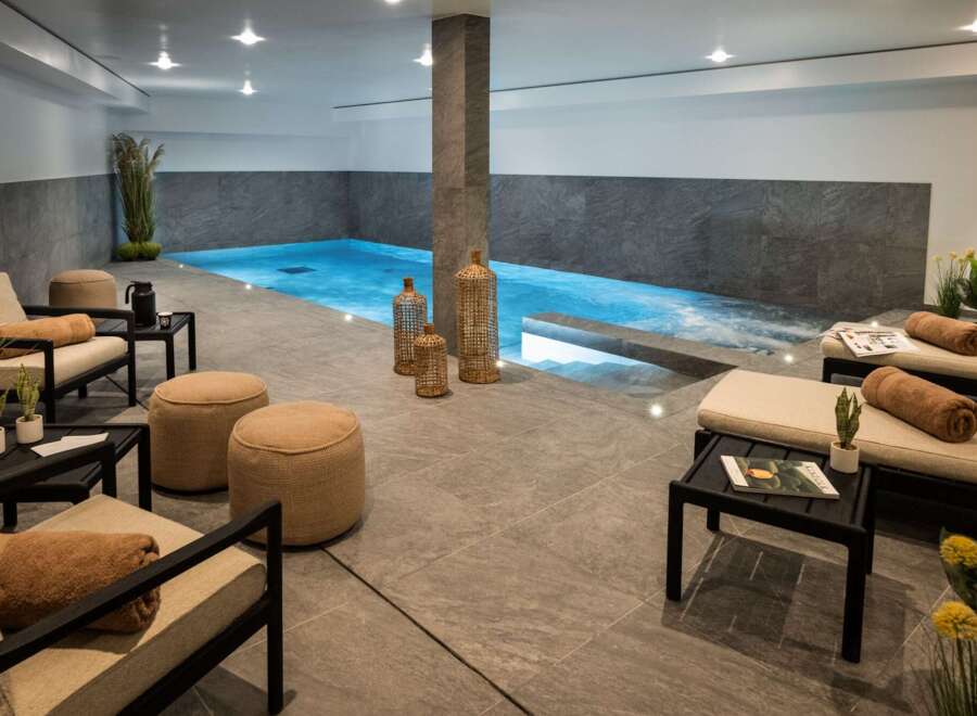 Indulge in the ultimate relaxation experience in this luxurious indoor pool and spa area.