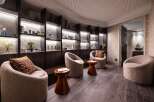 Relax in our luxurious spa, featuring plush seating areas and uniquely designed shelves stocked with premium skincare products.