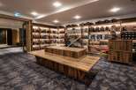 This ski rental shop boasts ample shelving for helmets, goggles, and other gear, with a modern, rustic design.