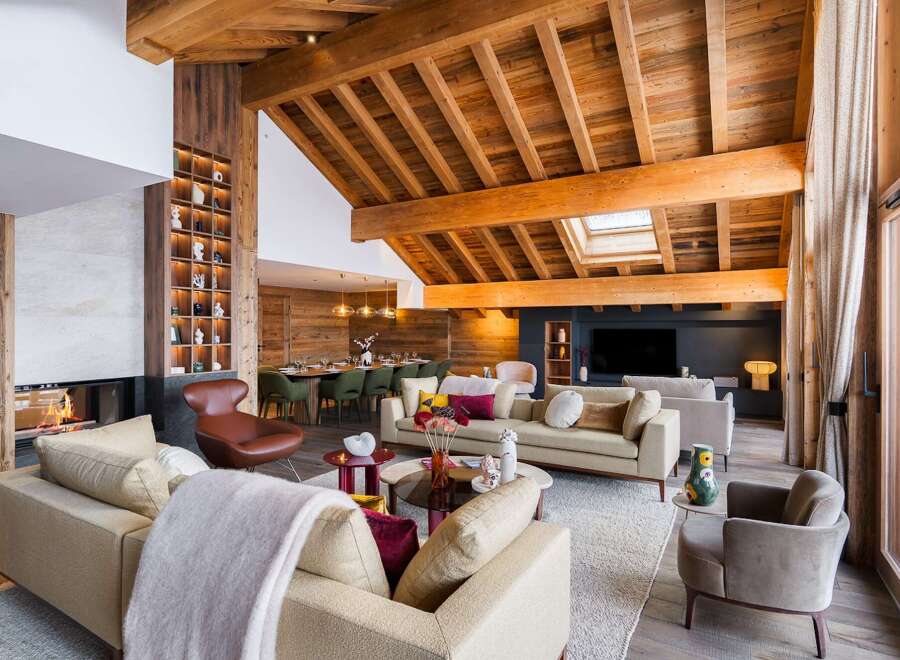 Experience luxury living in this stunning chalet, featuring a cozy fireplace and a spacious living area.
