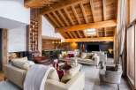 Experience luxury living in this stunning chalet, featuring a cozy fireplace and a spacious living area.