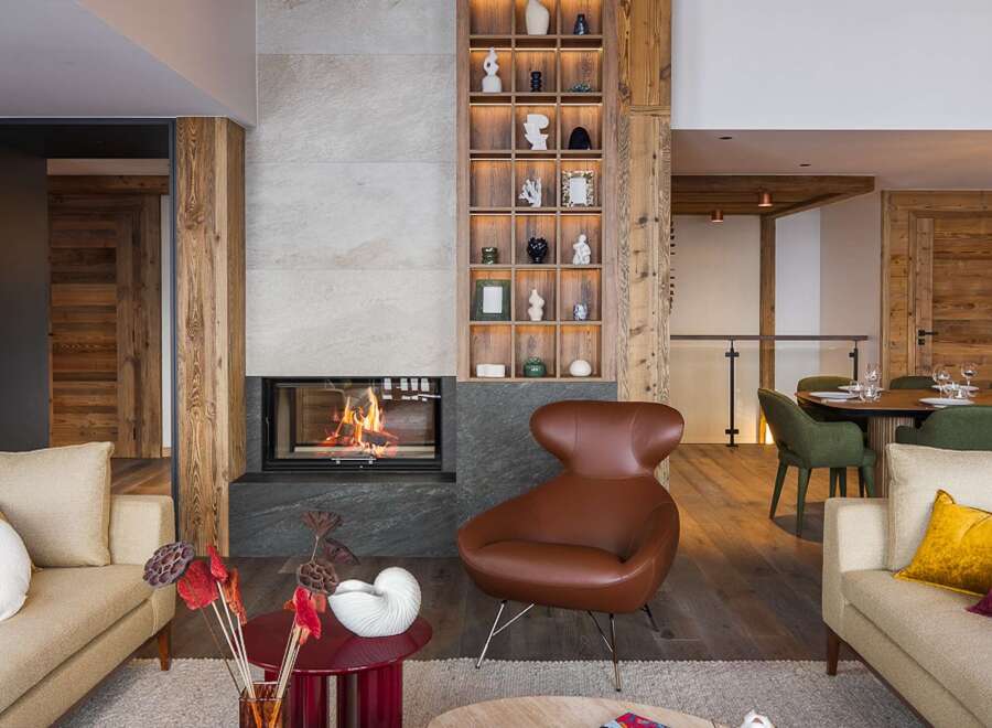 Experience luxury living in this stunning property featuring a cozy fireplace and a stylish seating area.