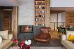 Experience luxury living in this stunning property featuring a cozy fireplace and a stylish seating area.