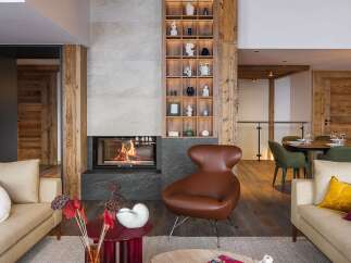 Experience luxury living in this stunning property featuring a cozy fireplace and a stylish seating area.