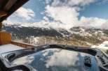 Indulge in luxury with this stunning property featuring a private hot tub overlooking breathtaking mountain views.