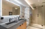 Step into luxury with this stunning bathroom featuring a sleek, modern design.