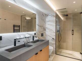 Step into luxury with this stunning bathroom featuring a sleek, modern design.