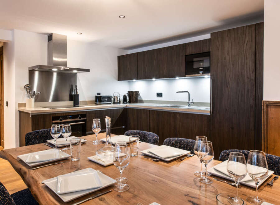 This stunning apartment boasts a modern kitchen with sleek dark wood cabinetry, stainless steel appliances, and a large island perfect for entertaining.
