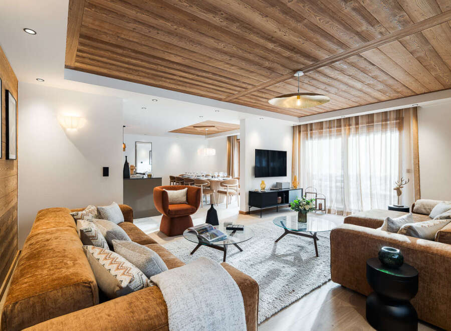 Experience luxury living in this stunning property, featuring a beautifully designed living room with a cozy seating area and a modern fireplace.