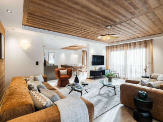 Experience luxury living in this stunning property, featuring a beautifully designed living room with a cozy seating area and a modern fireplace.