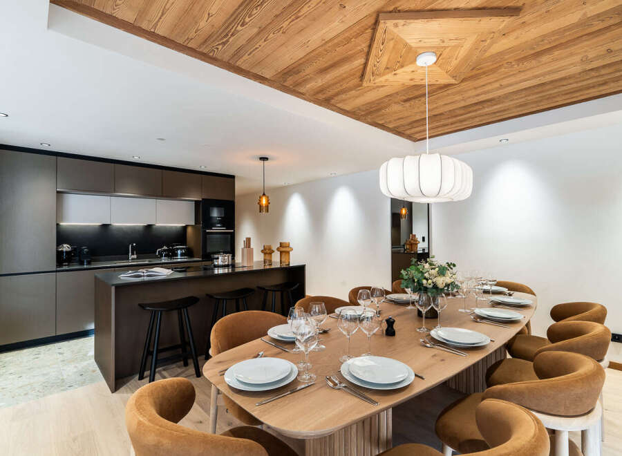 Experience luxury living in this stunning property featuring a modern kitchen with sleek cabinetry and a breakfast bar.