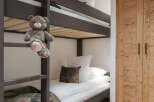 This cozy bedroom features a stylish bunk bed, perfect for kids or guests.