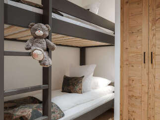 This cozy bedroom features a stylish bunk bed, perfect for kids or guests.