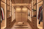Step into luxury with this stunning walk-in closet, showcasing exquisite wooden craftsmanship and ambient lighting.