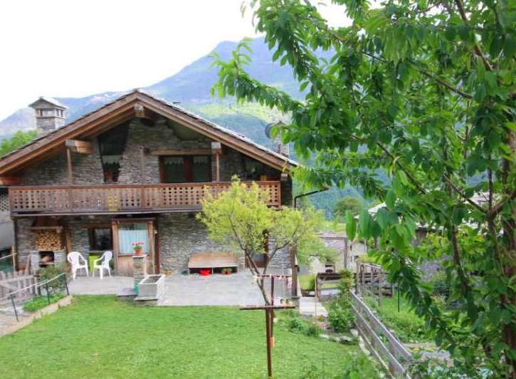Discover the charm of this stunning stone house nestled in a picturesque mountain setting.