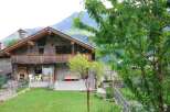 Discover the charm of this stunning stone house nestled in a picturesque mountain setting.