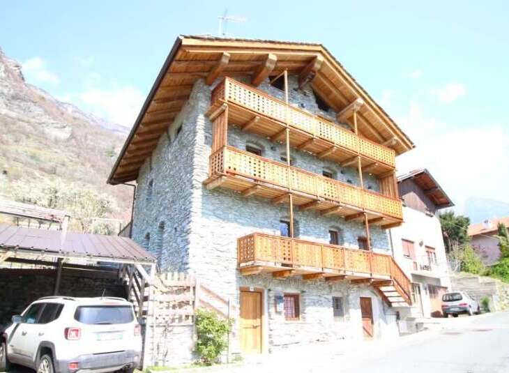 Discover the charm of this stunning stone house, featuring multiple wooden balconies that offer breathtaking views.