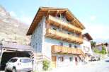 Discover the charm of this stunning stone house, featuring multiple wooden balconies that offer breathtaking views.