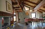 This charming property boasts a rustic interior with exposed wooden beams and a stone fireplace, creating a warm and inviting atmosphere.