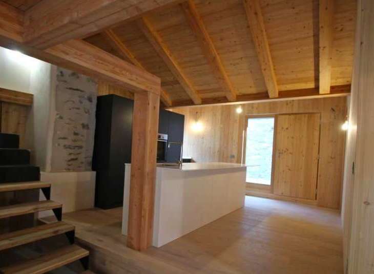 This stunning property boasts a warm and inviting interior with beautiful wooden accents throughout.