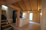 This stunning property boasts a warm and inviting interior with beautiful wooden accents throughout.