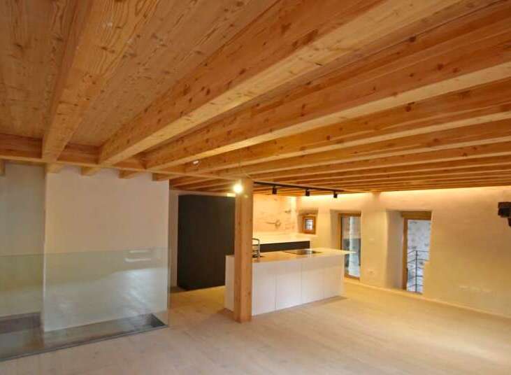 This stunning property boasts a beautifully designed interior with exposed wooden beams that add warmth and character.