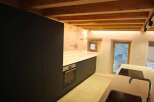 This stunning kitchen boasts a modern design with sleek black cabinetry and a minimalist aesthetic.