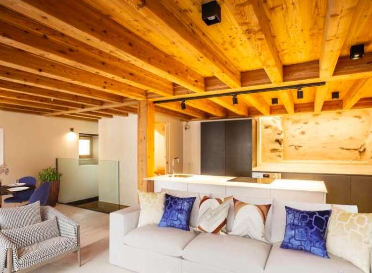 Experience rustic elegance in this stunning property, featuring exposed wooden beams and a modern kitchen.