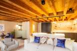 Experience rustic elegance in this stunning property, featuring exposed wooden beams and a modern kitchen.