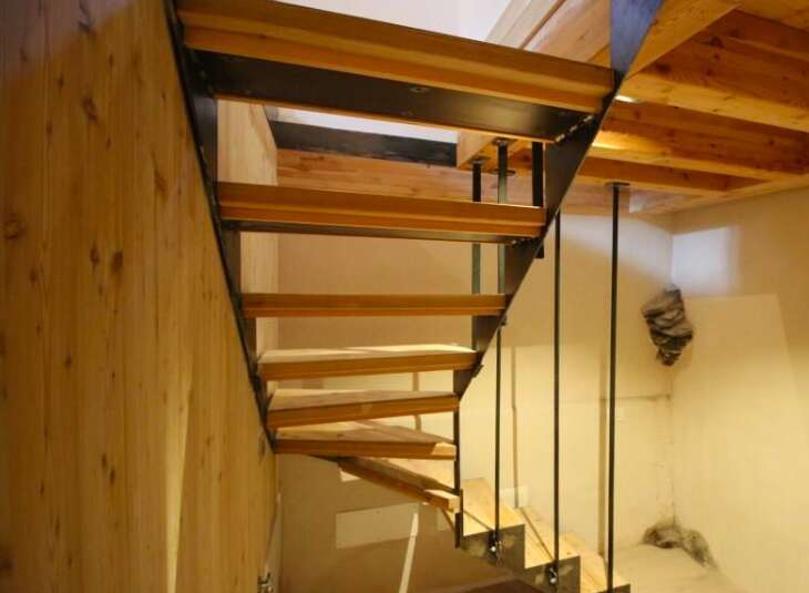 This stunning property boasts a unique staircase design, blending wood and metal for a modern aesthetic.