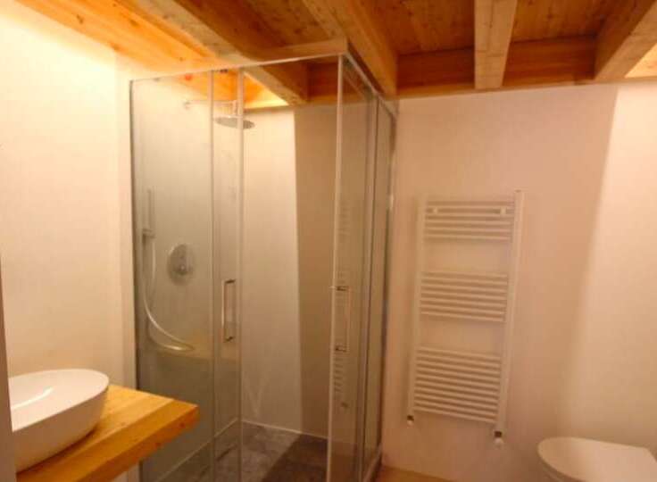Discover a modern bathroom with a sleek glass shower enclosure.