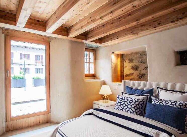 Discover the charm of this rustic bedroom, featuring exposed wooden beams and a cozy ambiance.