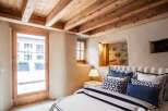 Discover the charm of this rustic bedroom, featuring exposed wooden beams and a cozy ambiance.