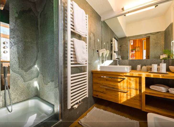 This luxurious bathroom features a modern design with a touch of nature.