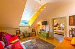 Discover the charm of this cozy attic room, perfect for a relaxing getaway.