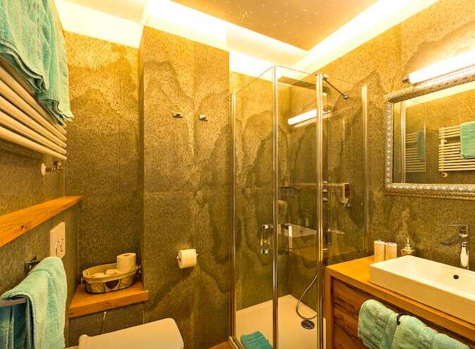 This stunning bathroom boasts a modern design with a touch of rustic charm.