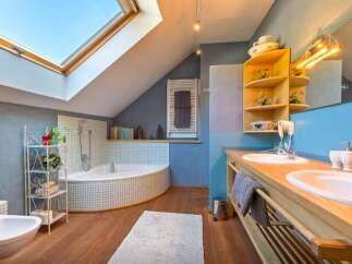 This stunning bathroom boasts a unique design with a skylight, creating a bright and airy atmosphere.