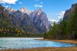 Explore the breathtaking beauty of this stunning landscape, featuring majestic mountains and a serene lake.