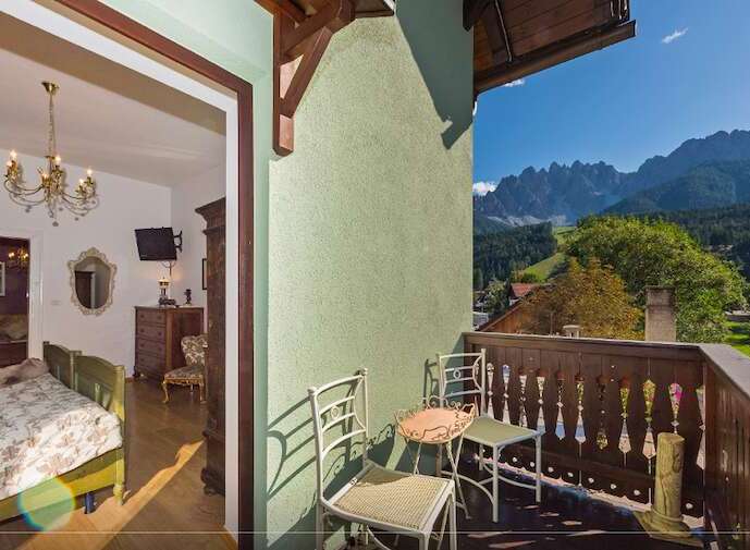 Enjoy breathtaking mountain views from this charming balcony.