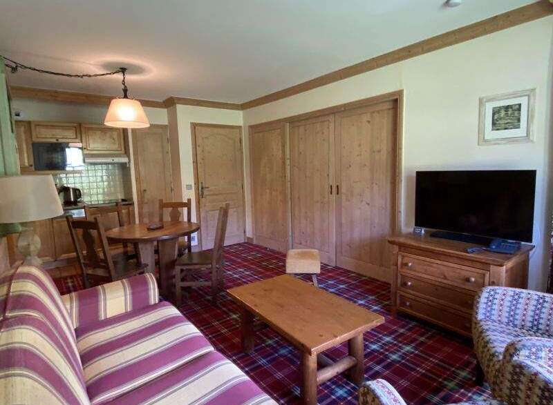 This cozy apartment features a charming living space with a comfortable sofa and a rustic wooden coffee table.