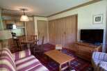 This cozy apartment features a charming living space with a comfortable sofa and a rustic wooden coffee table.