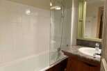 Discover a charming bathroom with a bathtub and shower combination.