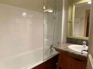 Discover a charming bathroom with a bathtub and shower combination.