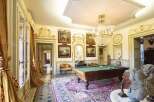 This luxurious estate boasts a stunning game room, complete with a classic billiard table and exquisite antique furnishings.