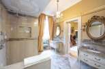 Luxury bathroom with marble finishes, a walk-in shower, and a freestanding bathtub.