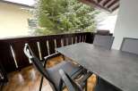 Enjoy the serene beauty of this balcony with a stunning view of snow-covered trees.